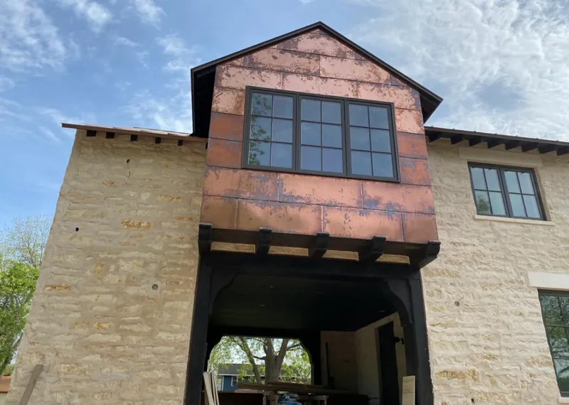Copper metal panel facade on a stone building for Skylight Installation in Lindsay